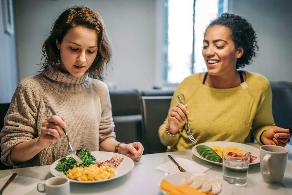 Two women enjoying a healthy breakfast together.