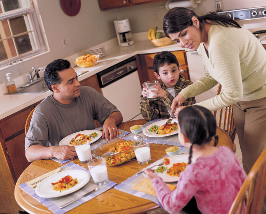 Family enjoying a meal together in kitchen.