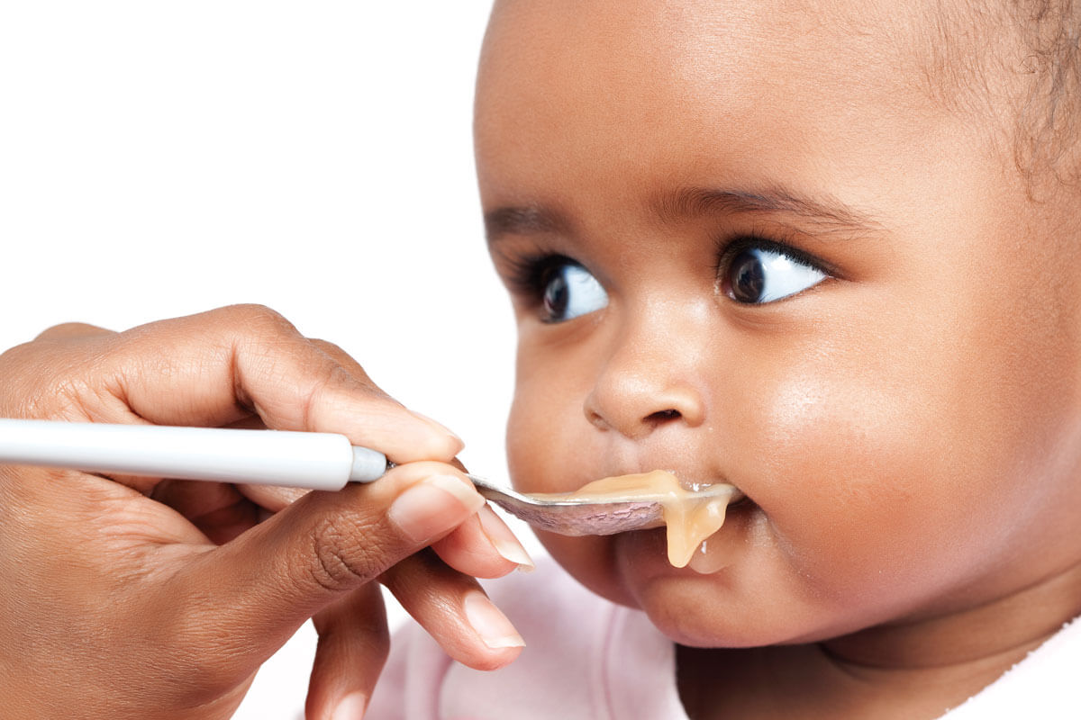 Baby being fed with a spoon.