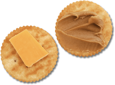Crackers topped with cheese and peanut butter.