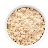 Bowl of cooked oatmeal, creamy and textured.