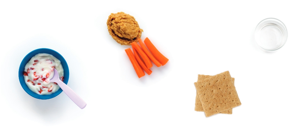 Yogurt with berries, carrot sticks, crackers, and water.