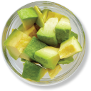 Diced avocado in a glass bowl, overhead view.