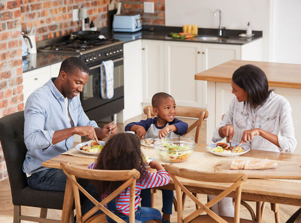 Family enjoying a meal together at dining table.
