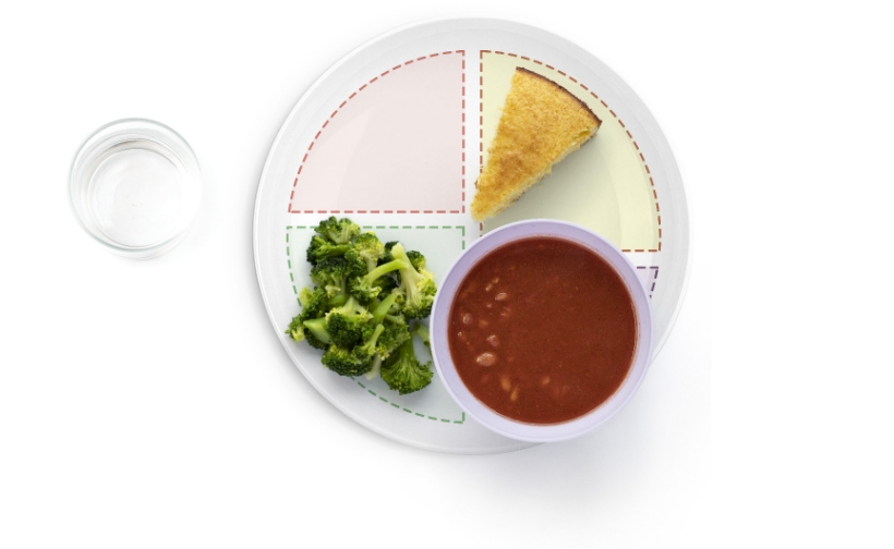 Cornbread, broccoli, and soup on a sectioned plate.