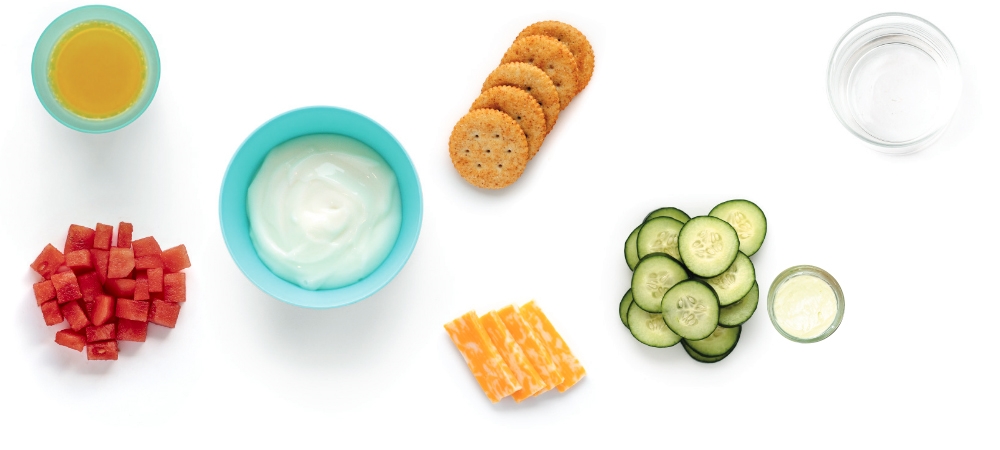Variety of snacks and drinks arranged on white background.