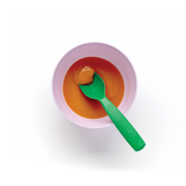 Baby food bowl with green spoon inside.