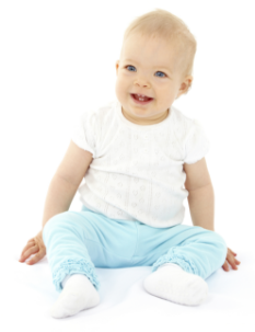 Smiling baby sitting in blue pants.
