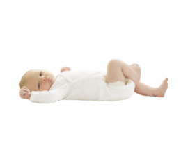 Baby lying down in a white outfit.