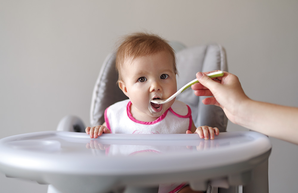 Baby being fed with a spoon.