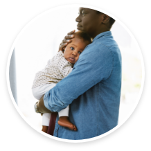 Parent gently holding their baby close, both looking serene.