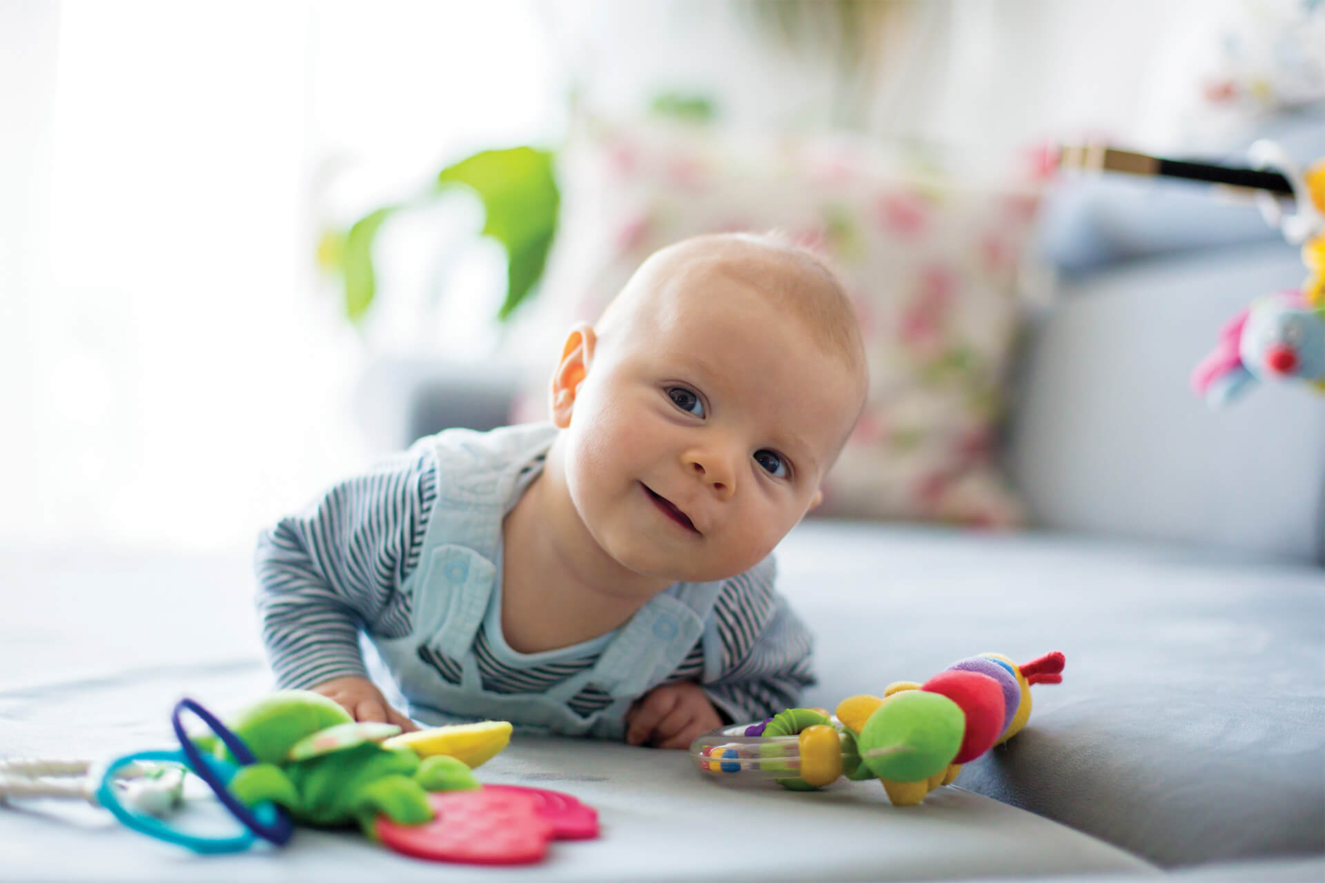 Smiling baby lying on a soft surface