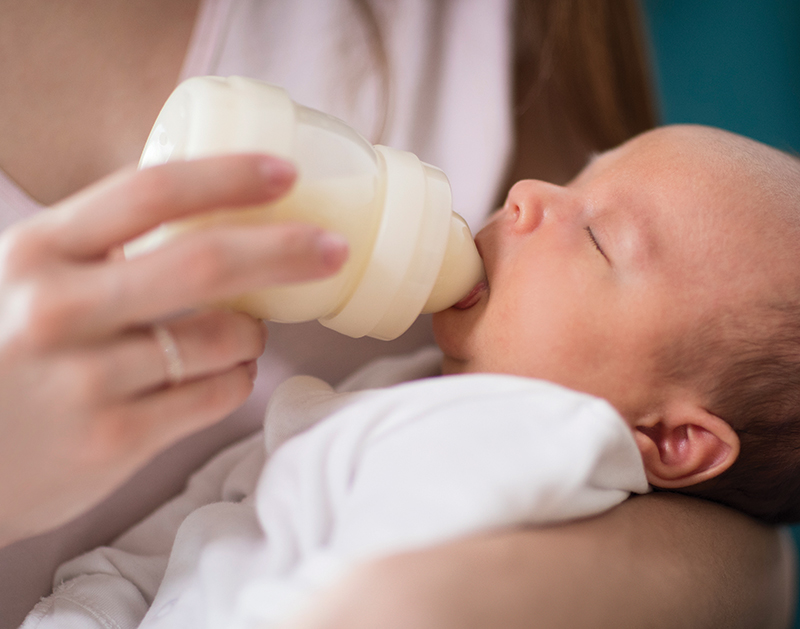 Baby bottle feeding close-up