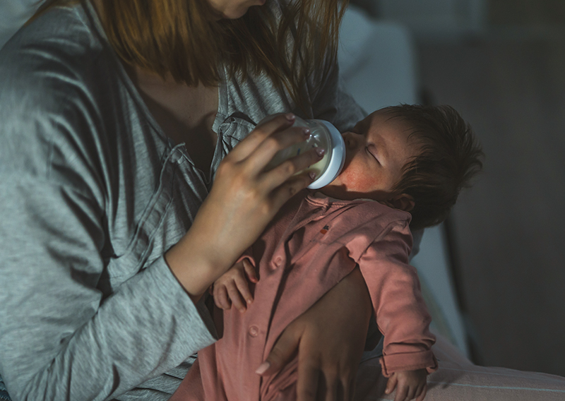 Baby feeding in arms