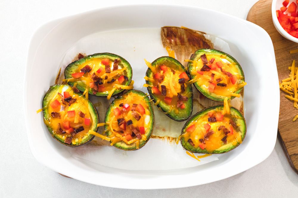 Avocado halves baked with cheese and diced peppers.