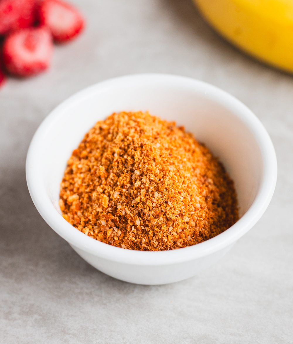 Bowl of ground spice on a kitchen counter.