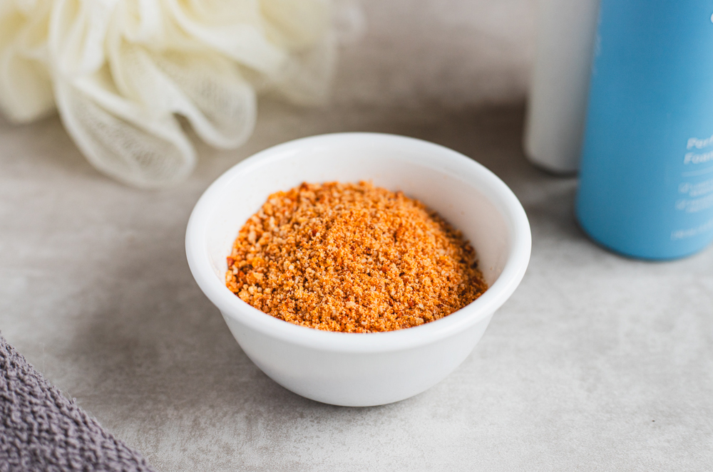 White bowl filled with brown sugar scrub.