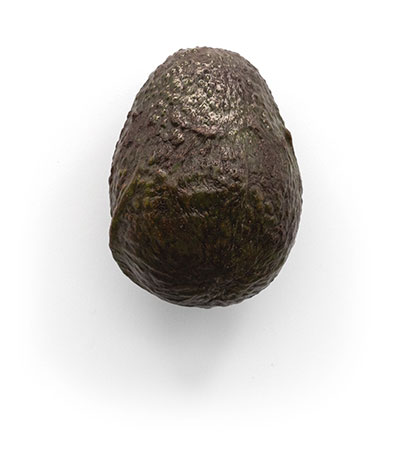 Whole avocado on a white background.