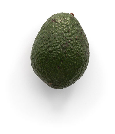 Ripe avocado on a plain white background.