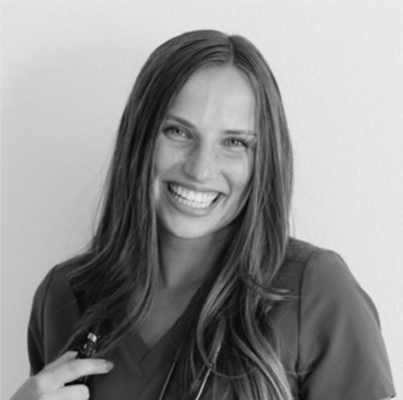 Smiling woman with long hair against plain background.