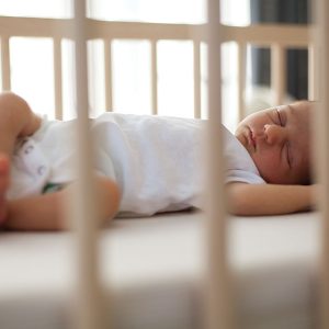 Sleeping baby peacefully in crib.