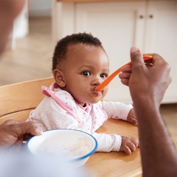 eating-baby Baby being fed with a spoon.
